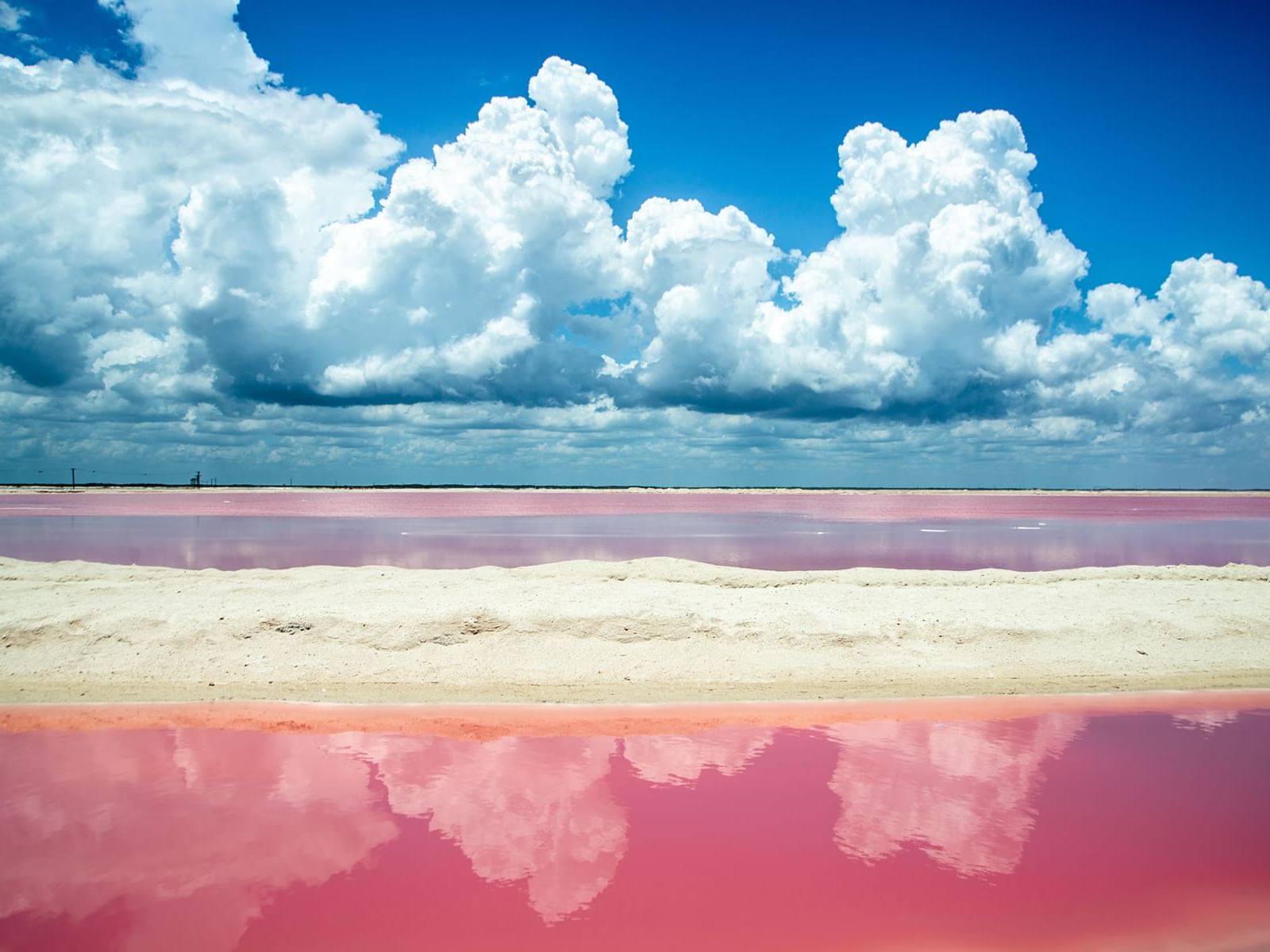 Pink salt lake and the blue sky with clouds, Fiesta Americana