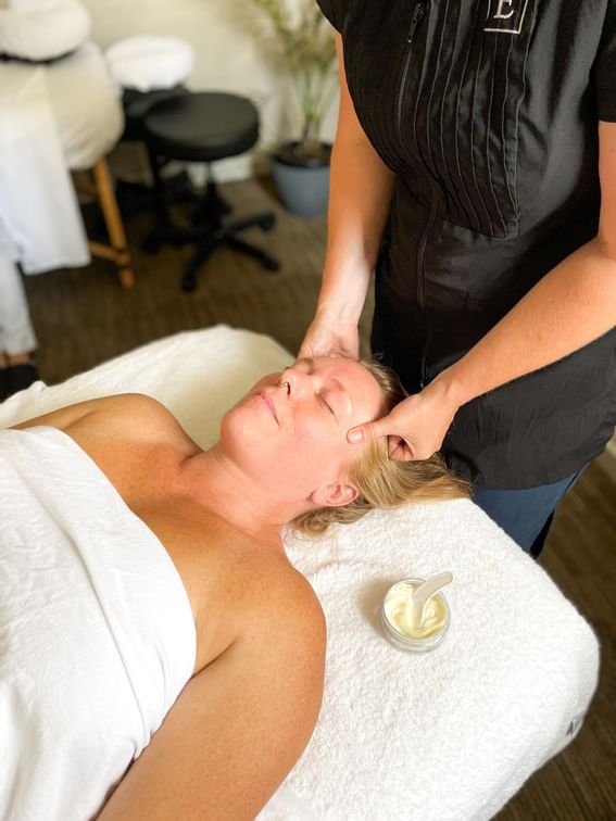 A woman receiving a massage at the Spa in Manteo Resort