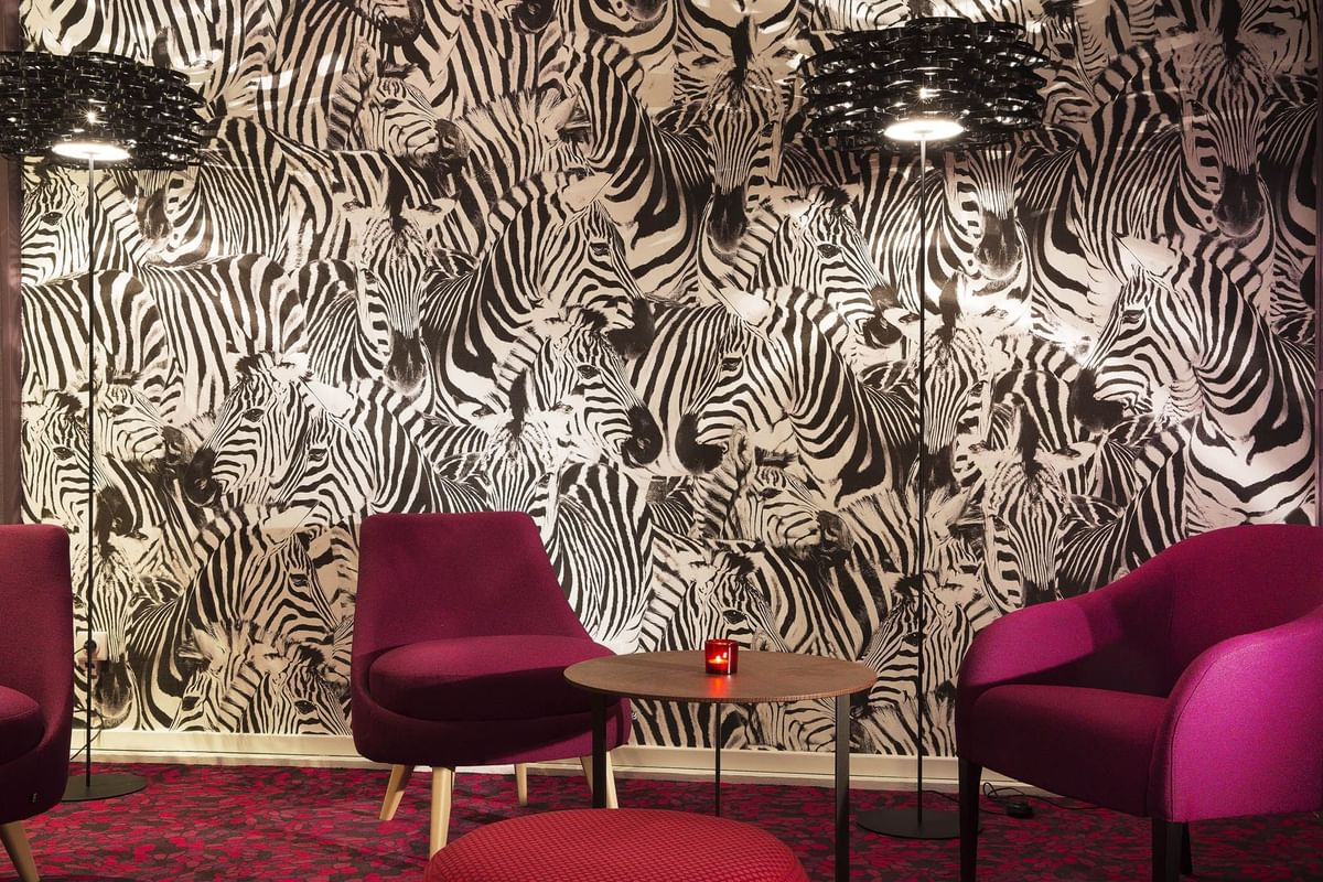 Lobby area with zebra designed wallpaper at Oceania Hotels