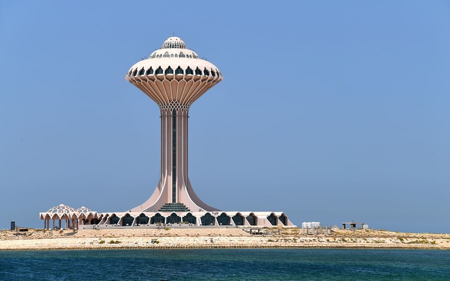 striking pink and white Al Khobar Water Tower on a coastal strip under a clear blue sky near Warwick Al Khobar