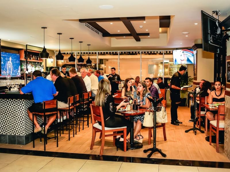 People lounging in Bar Papagayo at Gamma Hotels