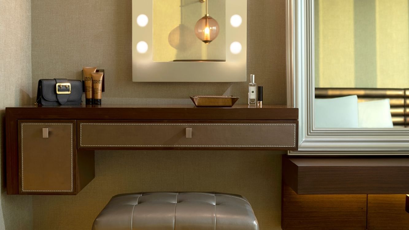 Vanity area featuring a lit mirror and skincare products in Premier Suite with Panoramic View at Paramount Hotel Dubai