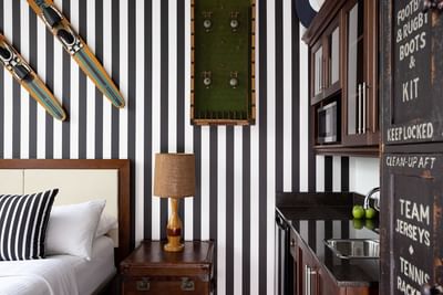 Cozy bed & nightstand with pantry in Queen Premiere at Retro Suites Hotel