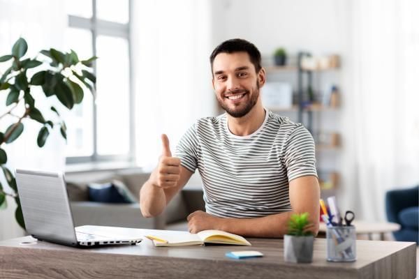 Man remote working, a perk part of his companies culture of wellbeing programme