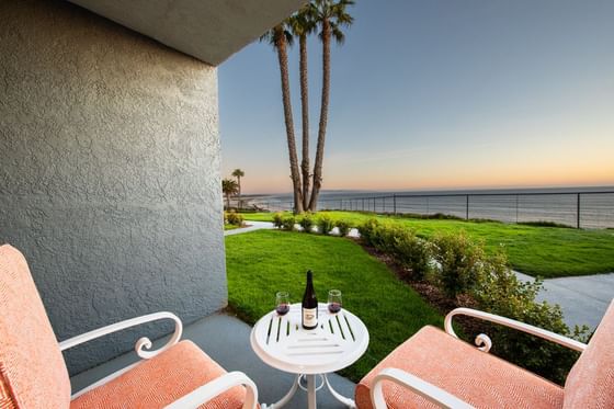 Arranged seating on the balcony overlooking the ocean in Coastal View Two Queens at SeaCrest Oceanfront Hotel Pismo Beach