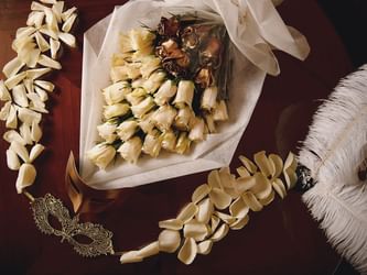 Close-up of flower bouquet & masquerade masks at Palazzo Versace