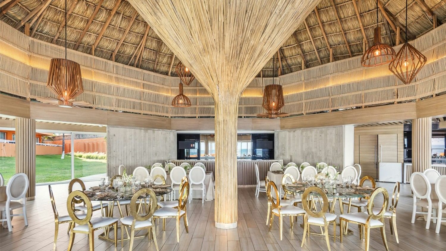 Elegant dining area with wooden tables and chairs, bamboo ceiling at Grand Fiesta Americana Veracruz.