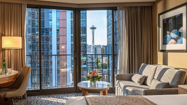 Premier Room features Grey sofa by a marble coffee table under a city view window at Warwick Seattle