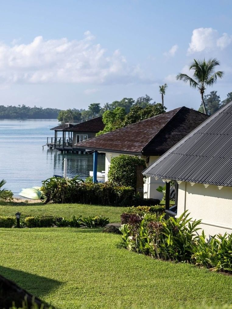 Picturesque view of Garden View Room and palm trees along a serene ocean shoreline