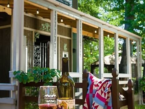a glass of wine and chairs outside