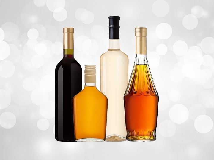 Four bottles of random liquor against a silver background