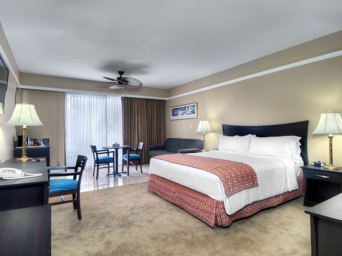 bed in carpeted hotel room with furniture