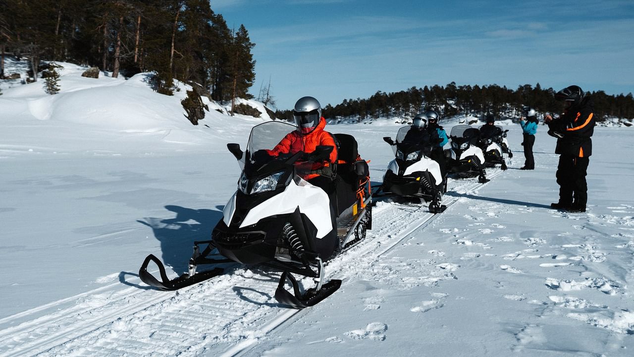 Group of people on snowmobiles