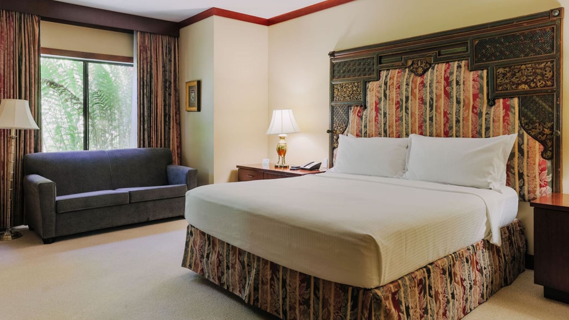 Large bed in Fountain Signature Suite at Dinah's Garden Hotel