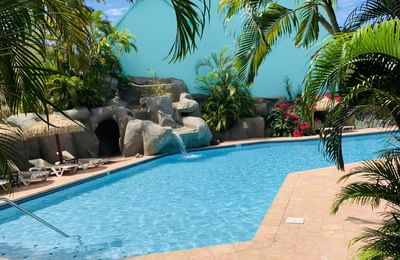 Pool & rock waterfall at Emerald Beach Resort, relaxing oceanfront moments at a St. Thomas resort with pool facing the ocean