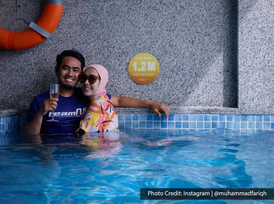 romantic couple posing together in the private pool at Lexis Resort