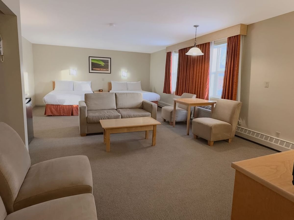 hotel room sitting area with two queen beds