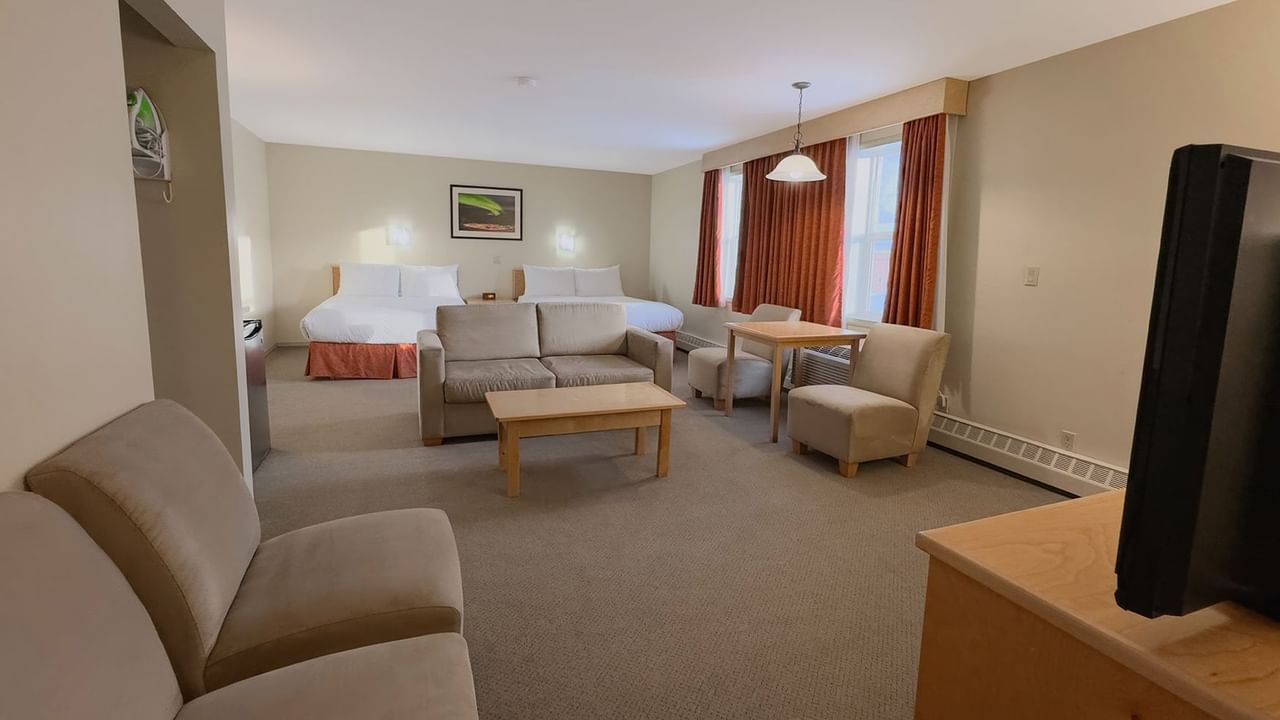 hotel room sitting area with two queen beds