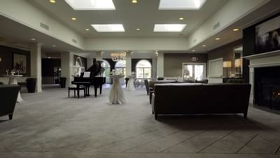 Wedding hall area with decors & a piano at Ethan Allen Hotel
