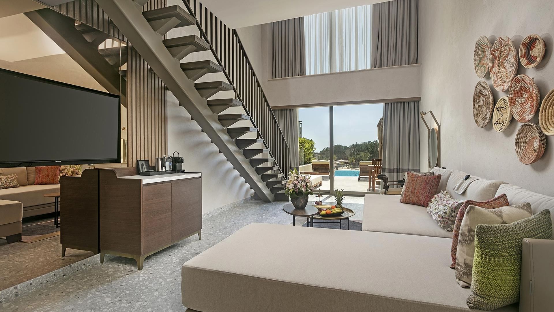 Living room with TV, staircase and view of the outdoors in Superior Duplex Swim-up at Cullinan Belek