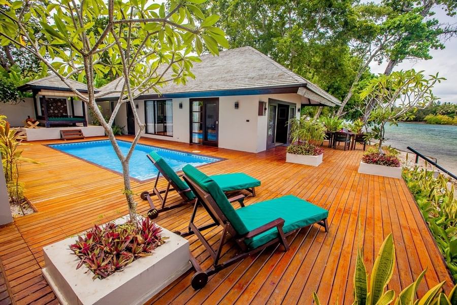 Pacific Pool Villa featuring teal loungers with private pool, and lush green tropical trees at warwick le lagon-vanuatu