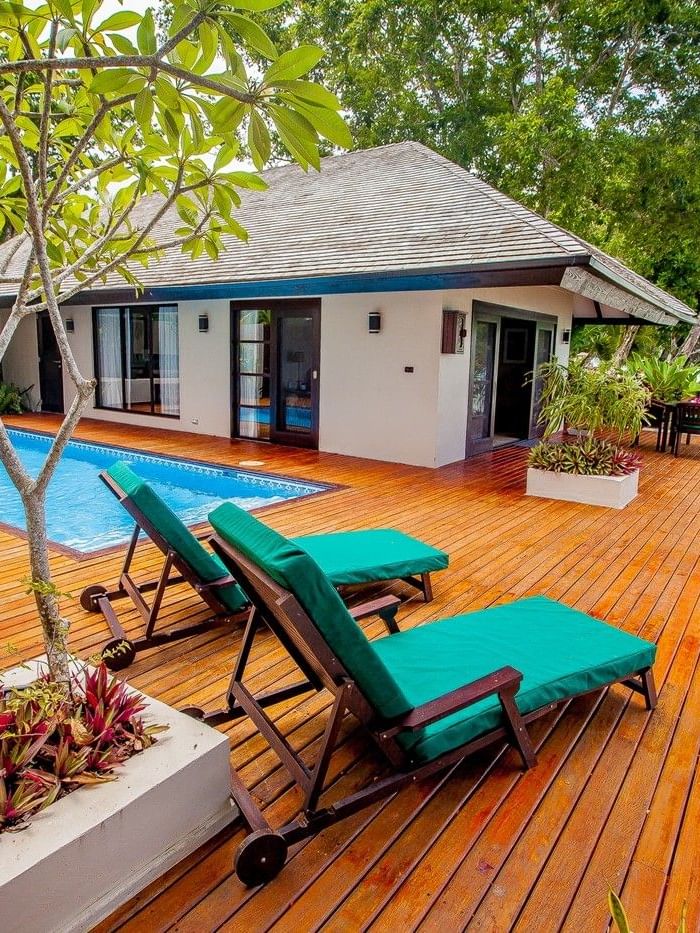 Pacific Pool Villa featuring teal loungers with private pool, and lush green tropical trees at warwick le lagon-vanuatu