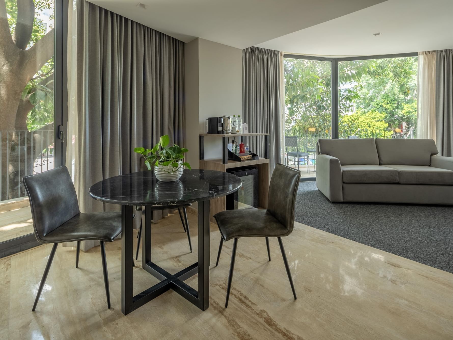 Elegant suite interior with dining area and sofa at Elements by Marquis, Ciudad de México.