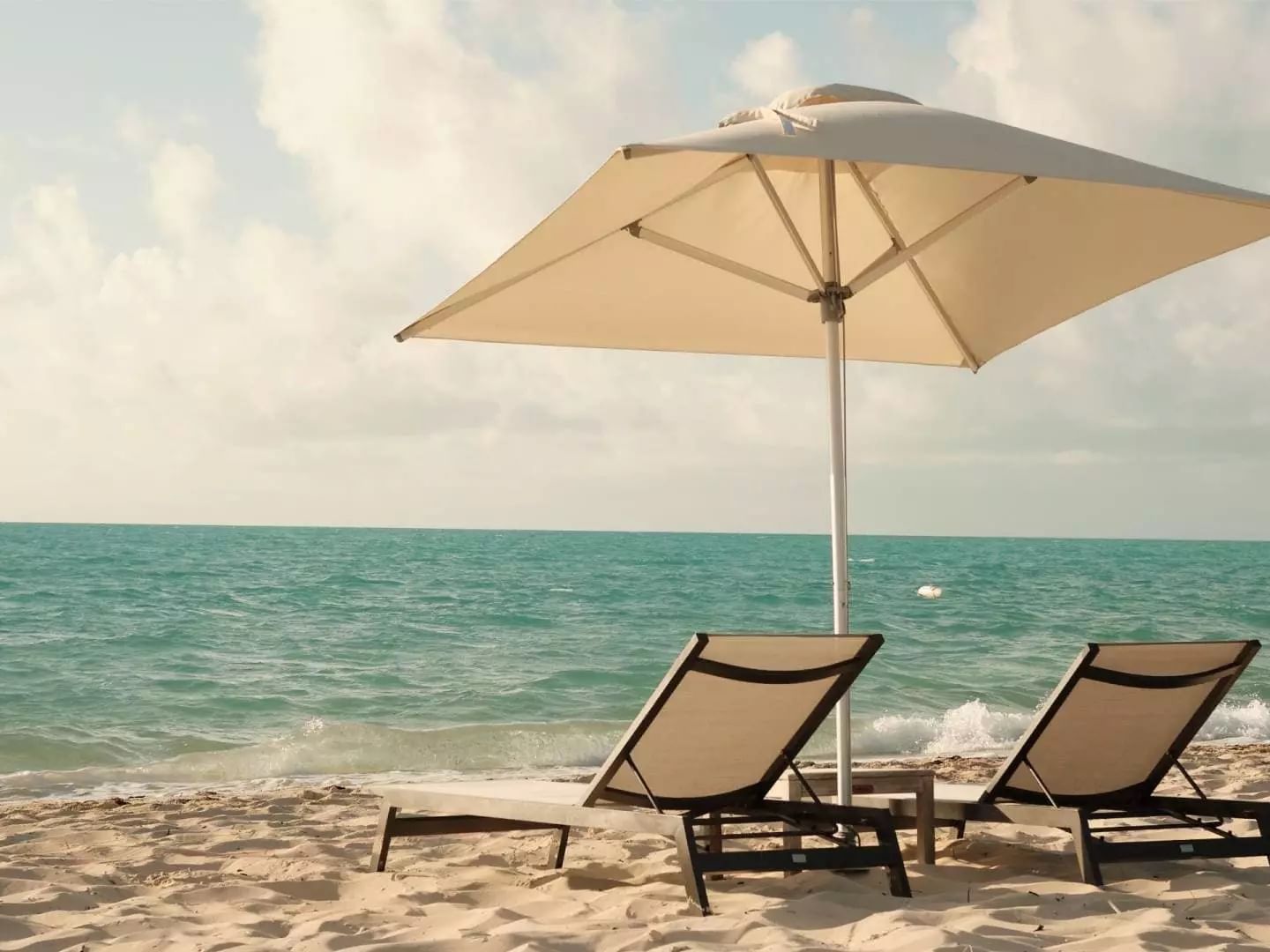 Lounge chairs & an umbrella by the beach, H2O Life Style Resort