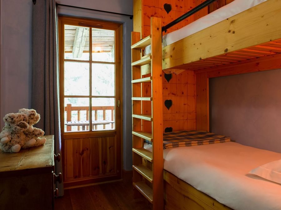 Bunk bed in the bedroom at Chalet Hotel La Ferme du Chozal