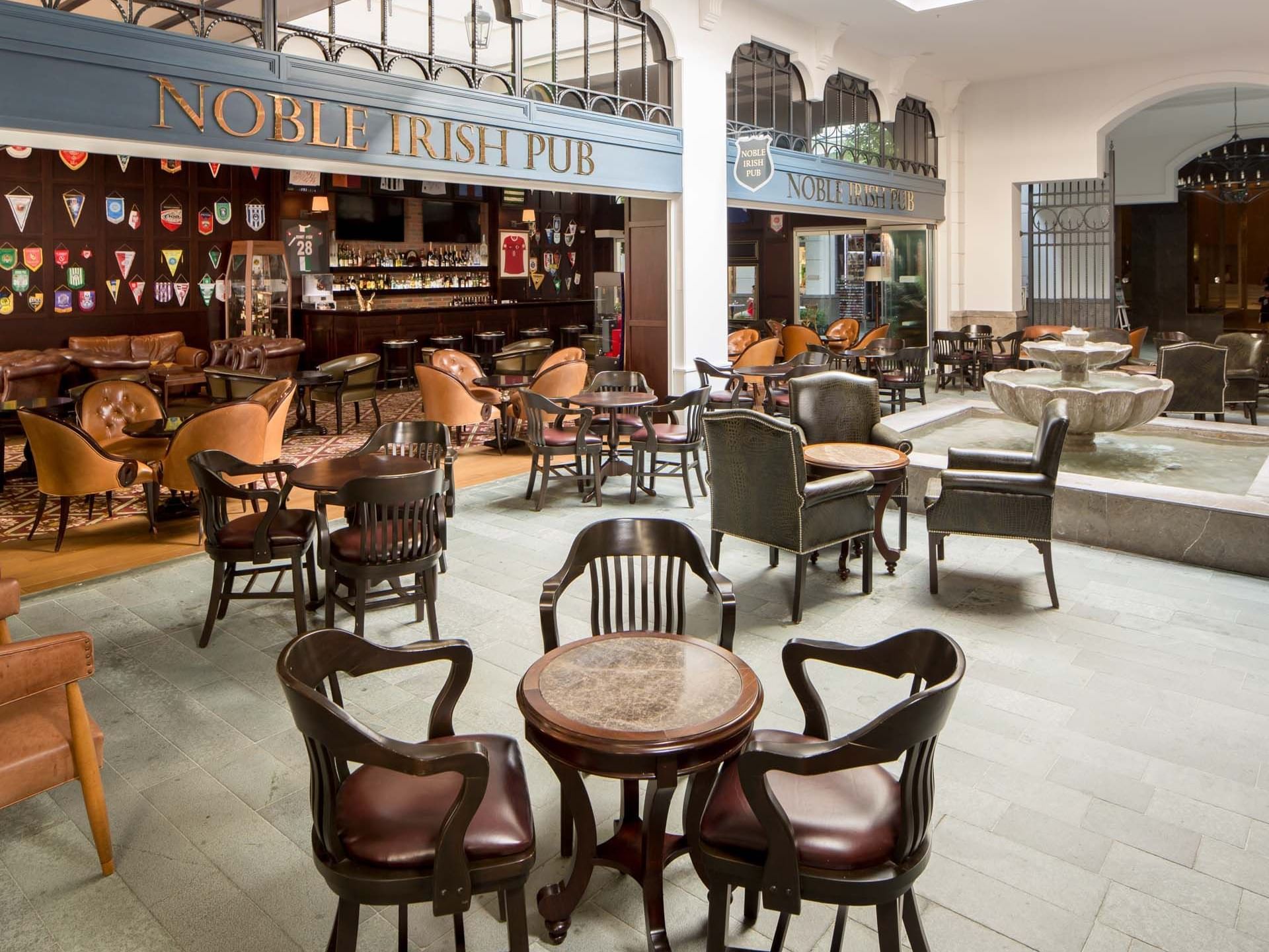 Dining area arranged with tables and chairs in Noble Irish Bar at Titanic Deluxe Golf Belek
