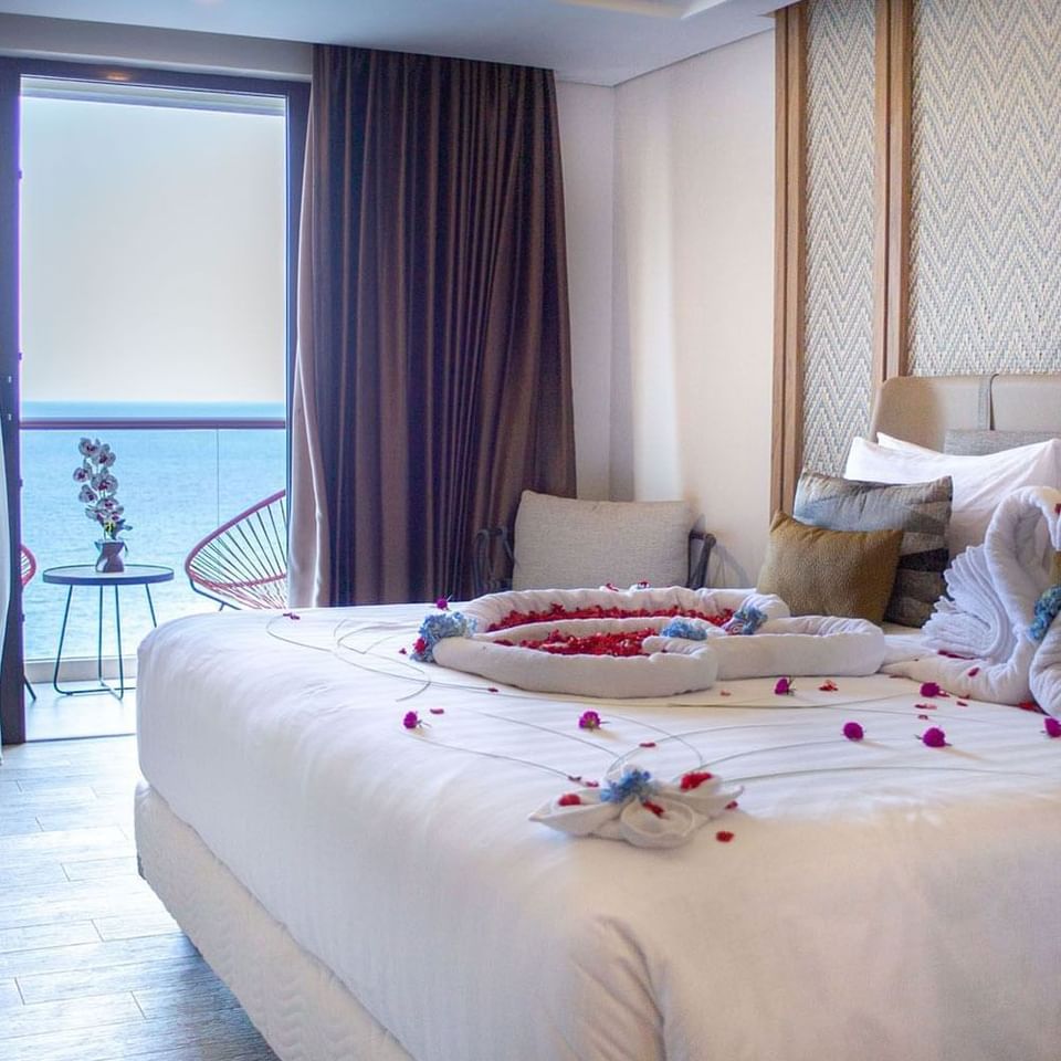 Decorated double bed in Premiere Sea View with Balcony at LK Resort Senggigi Lombok