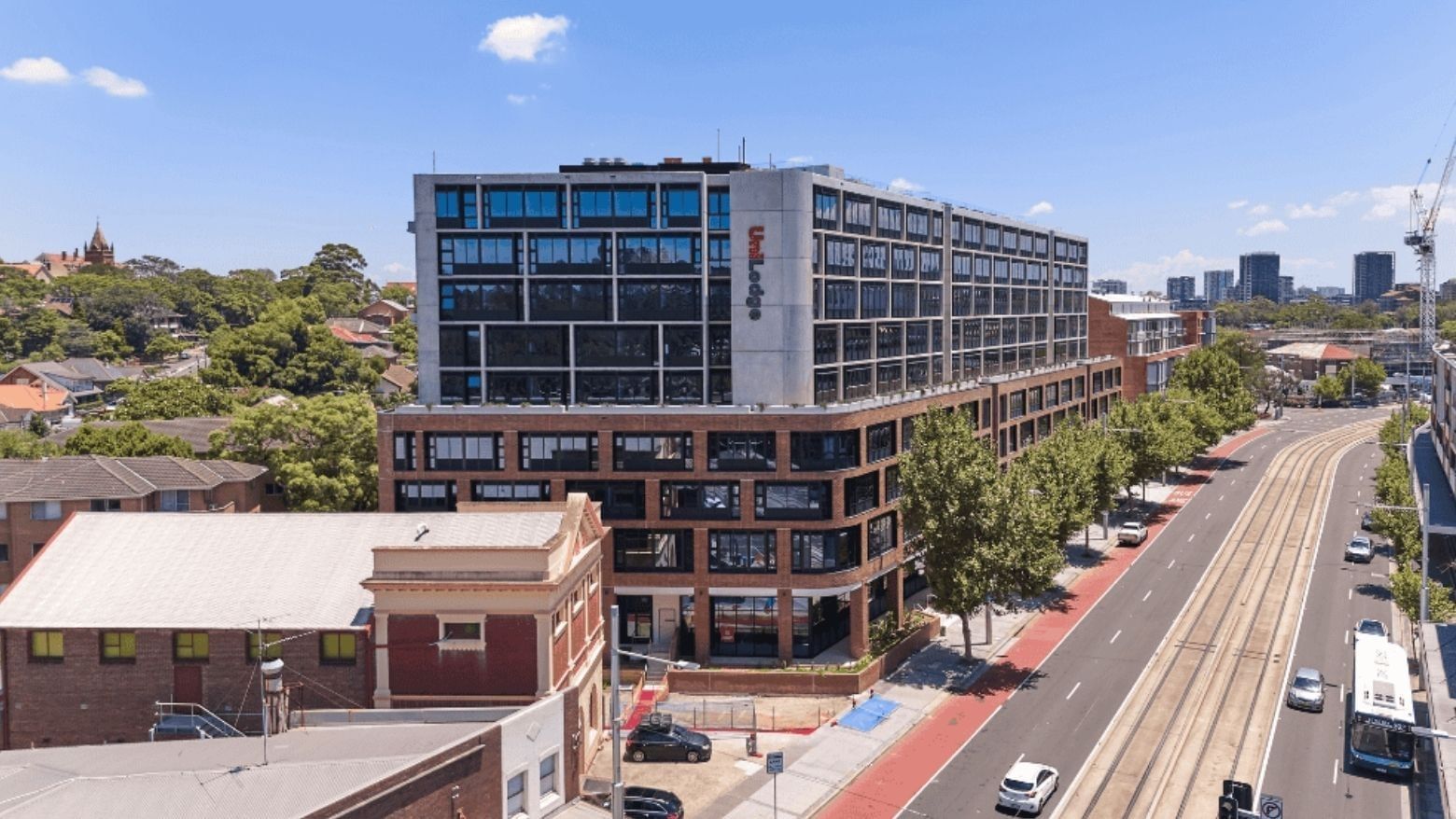 A modern purpose-built student accommodation building on a busy road
