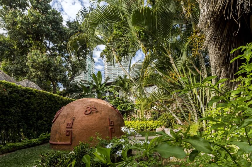 a circular hacienda surrounded by plants