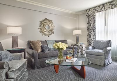 Living room with grey sofa in a guest room at The Eliot Hotel