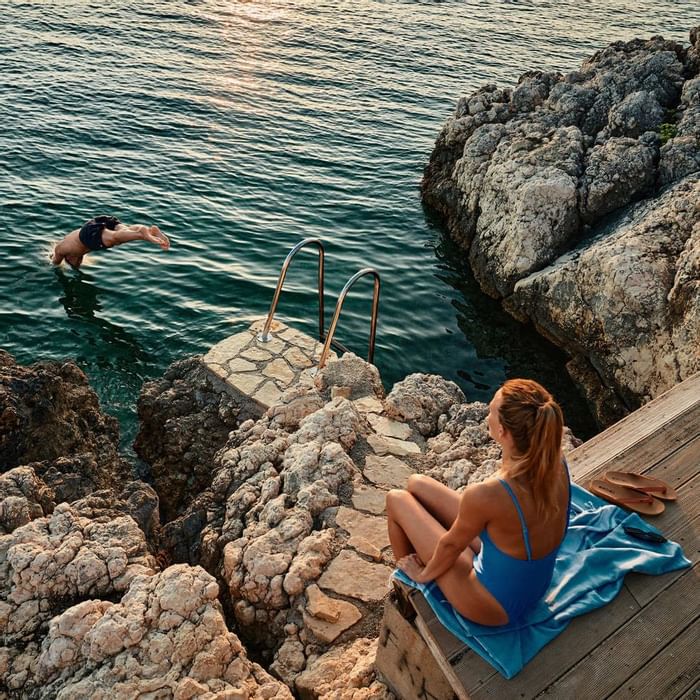 Lady by the deck & man diving to the sea, Falkensteiner Hotels
