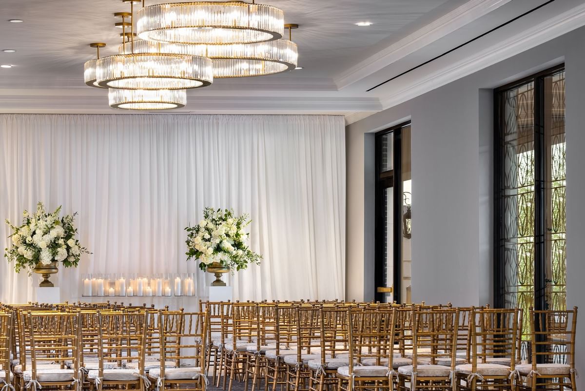 Arranged chairs and floral arrangements in the Turtle Creek Ballroom, Dallas, at Warwick Corporate