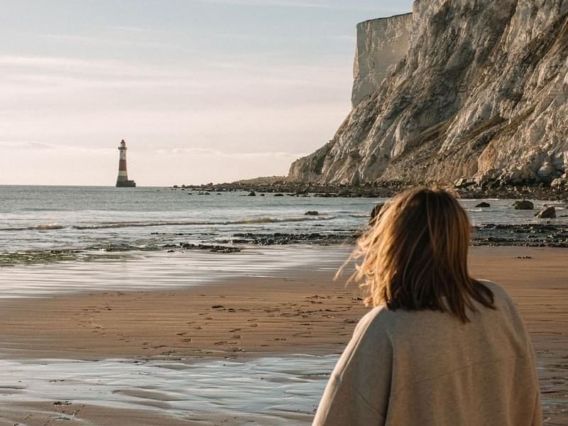 woman stood on beach during winter