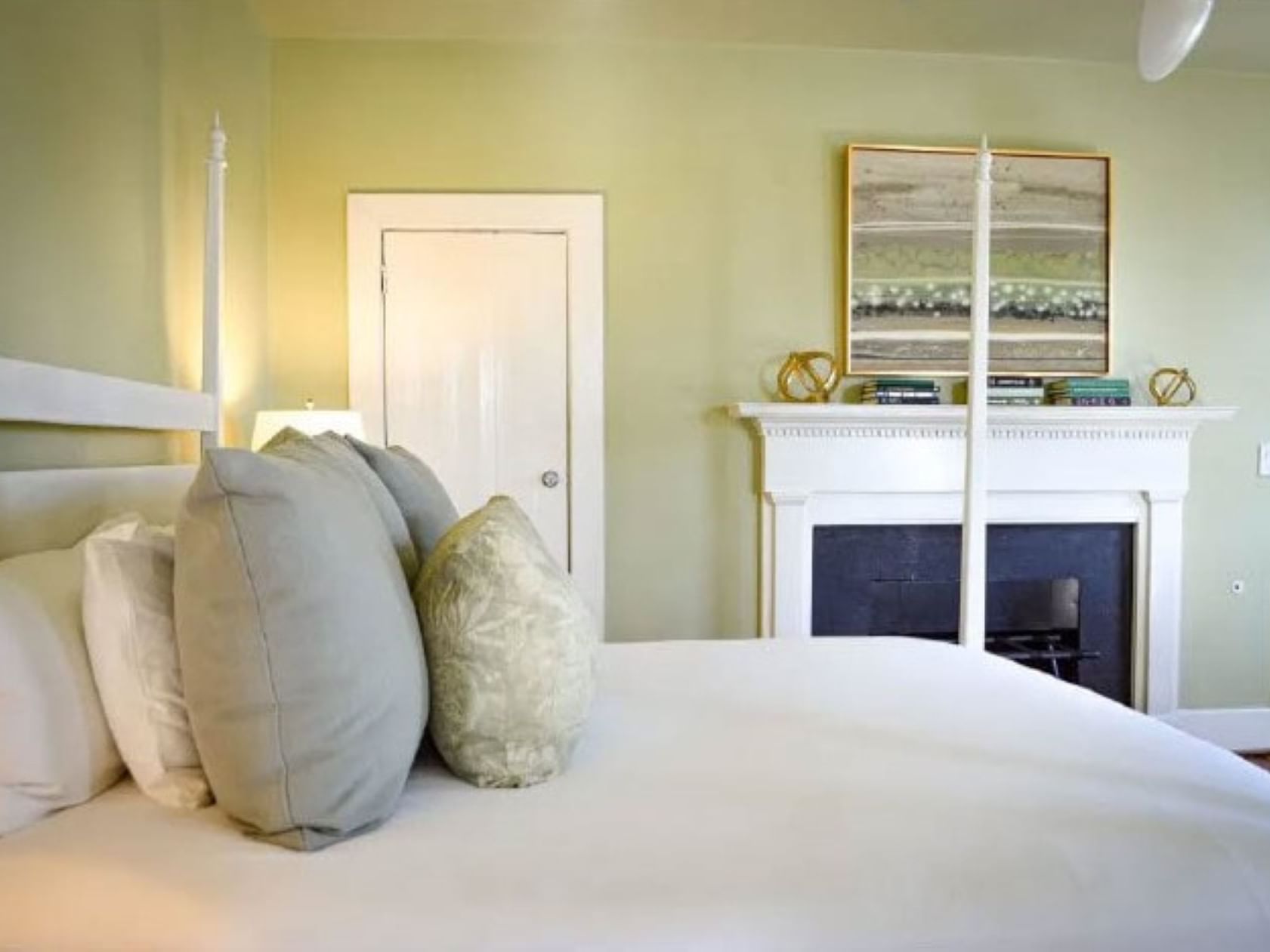 Cozy bed, nightstand & wall paintings in Martha Jefferson at The Clifton