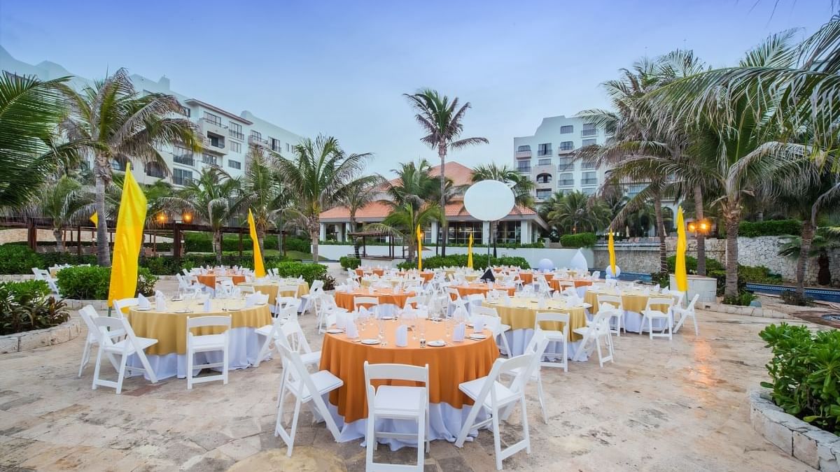 Outdoor dining area near the pool at FA Condesa Cancún