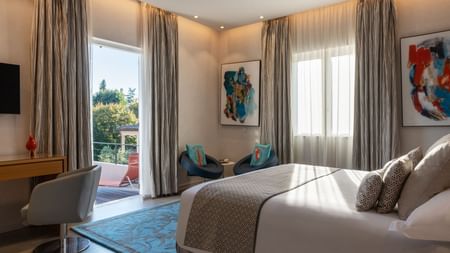 Interior of a bedroom with a balcony at Originals Hotels