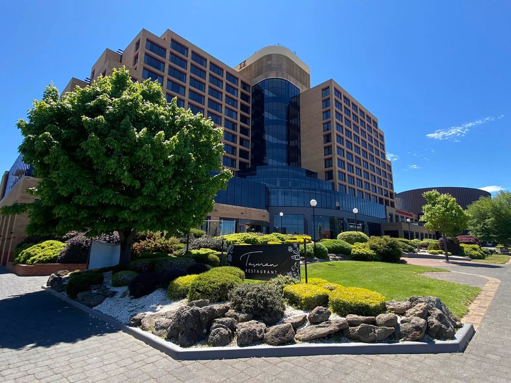 Front exterior view with the garden & welcome sign of Tasman Restaurant at Hotel Grand Chancellor Hobart