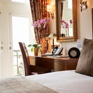 King bed and working desk in a room at Guoman Hotels