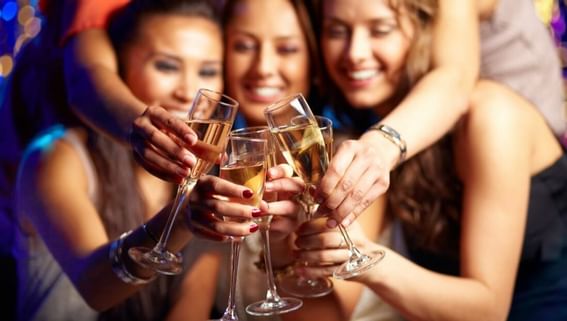 girls toasting champagne at prom