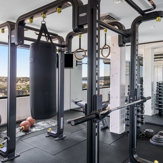 Fitness Centre with exercise machines and a view of the city at Pullman Sydney Hyde Park