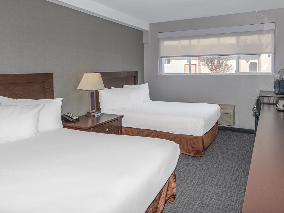 Two comfortable beds in a room with amenities.