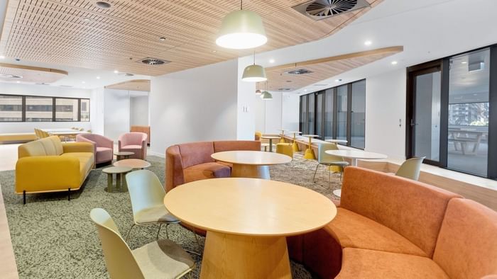 Modern resident lounge with comfortable seating and tables at UniLodge Brisbane City.