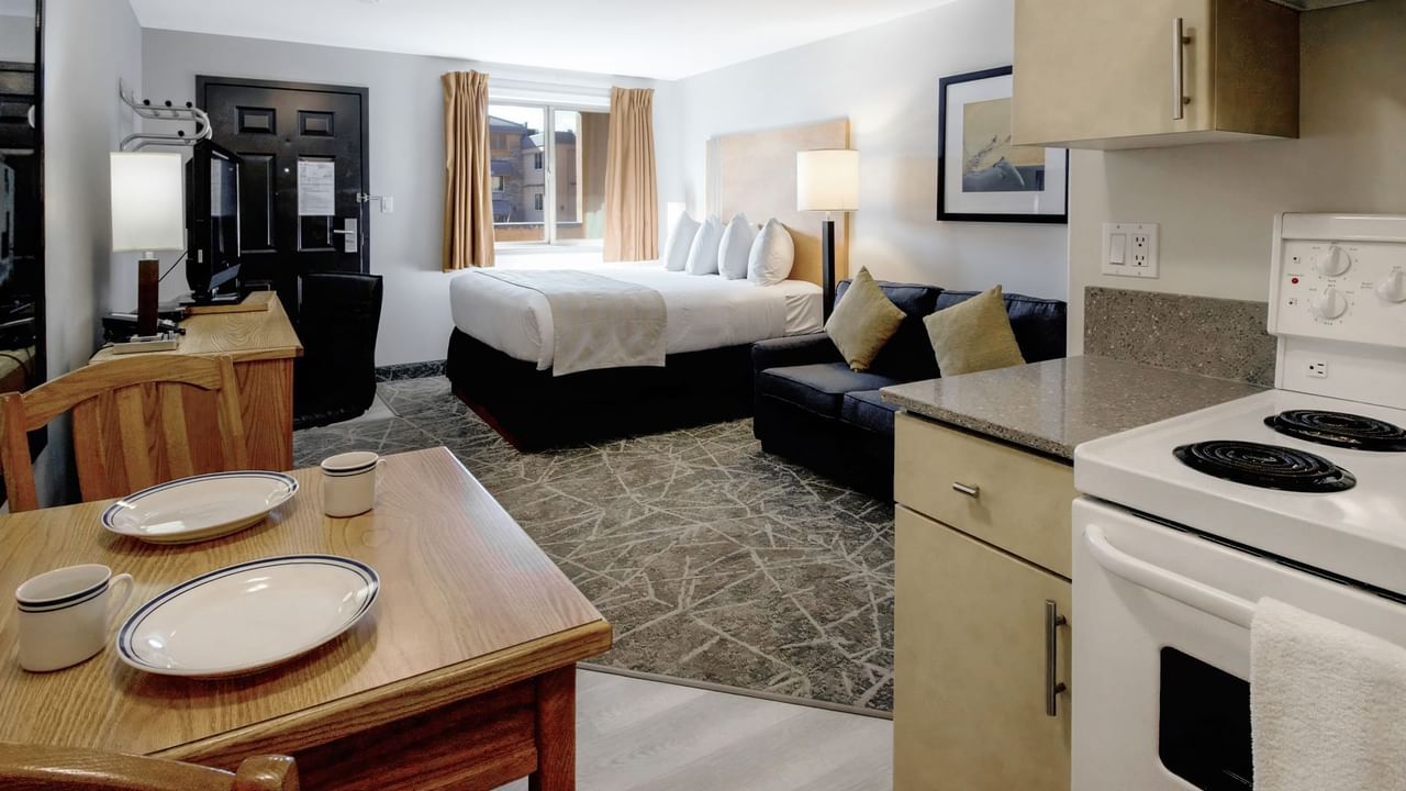 A cozy kitchenette setup with a small dining table with plates and cups.