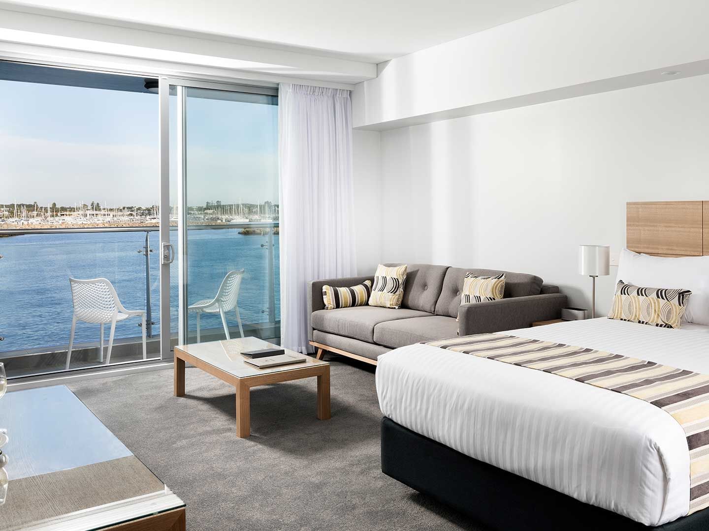Studio Ocean Sunrise with one bed and a couch at Be Fremantle