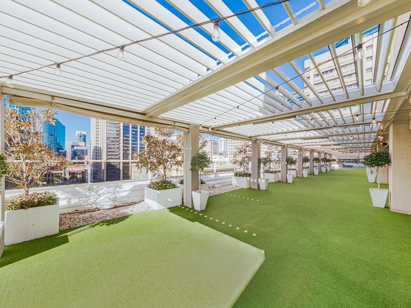 Rooftop garden with artificial grass and skyline view in Soiree Deck at Sofitel Brisbane Central