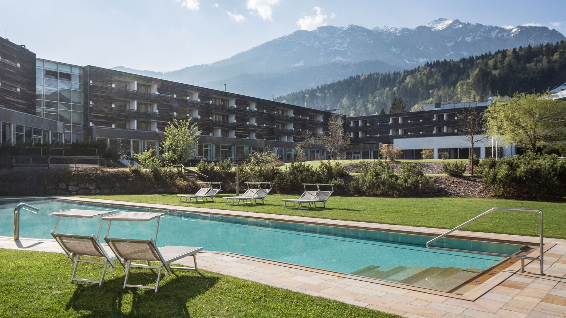 Pool with hotel exterior at Falkensteiner Hotel & Spa Carinzia